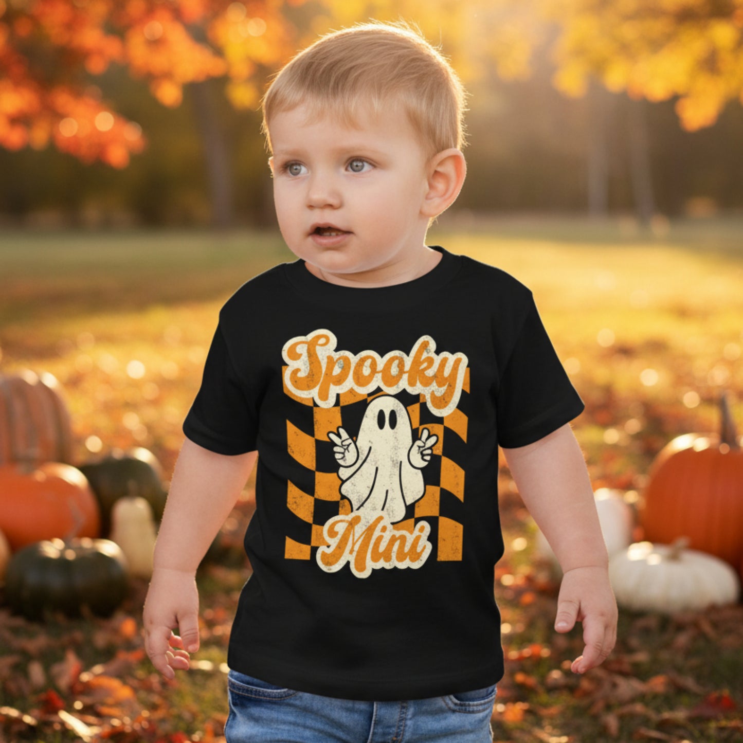 Retro inspired toddler Halloween shirt featuring a playful ghost and Spooky Mini Vibes lettering in orange and cream on black. A festive Halloween outfit for toddlers that coordinates with matching family shirts for Halloween photos, pumpkin patch adventures, and family celebrations.
