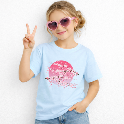 Kids Japanese inspired t shirt featuring a detailed cherry blossom graphic with delicate pink flowers and a moon inspired background. A cute floral graphic tee for casual outfits, spring style, and everyday wear.