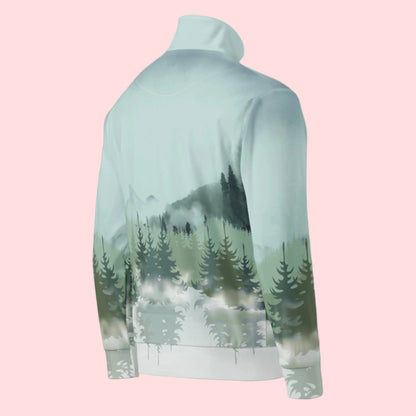 Image: Winter Forest Unisex Track Jacket. This nature inspired workout jacket has an ombre snowy mountain print that fades from a blue gray sky to mountains and pine trees to white snow. Suitable for men and women, by jaecrece