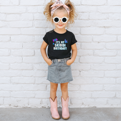 Toddler birthday graphic tee featuring the It’s My Skibidi Birthday message with colorful playful graphics and bold blue and white lettering, making a funny birthday shirt for a Gen Alpha toddler celebration