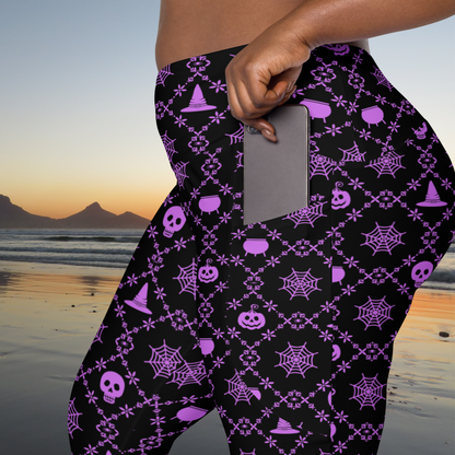 Size inclusive Halloween leggings for women with a high waist, compression fit and two functional pockets, featuring a playful purple and black geometric spooky pattern, available in sizes 2XS through 6XL for Halloween outfits, fall activities, workouts and everyday wear