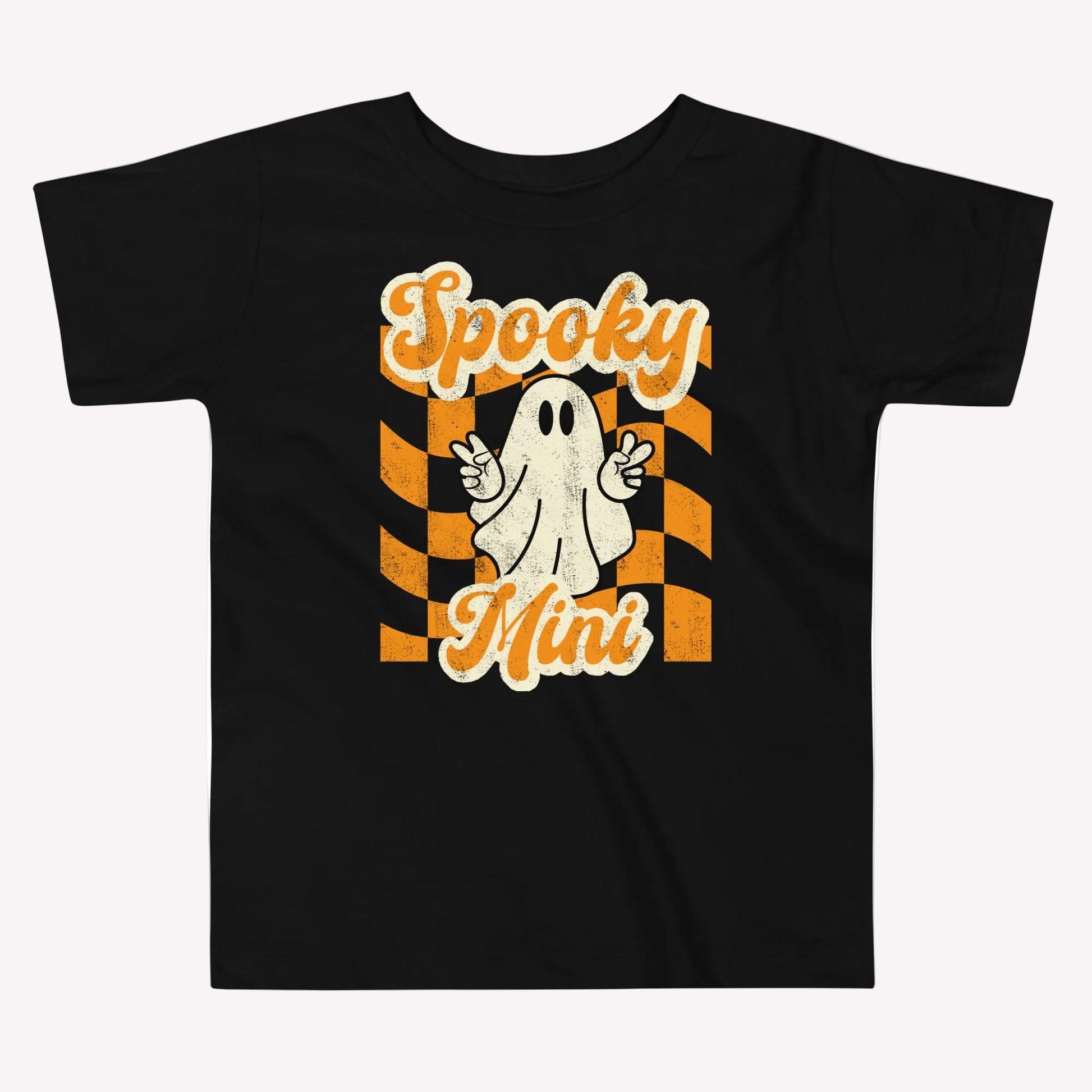 Cute black Halloween shirt for toddlers featuring a ghost, Spooky Mini Vibes lettering, and vintage inspired orange and cream graphics. A fun toddler Halloween tee for family pictures, pumpkin patch outings, Halloween parties, and coordinating family Halloween outfits.