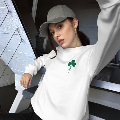 Cozy white crewneck pullover sweatshirt with embroidered green clover and Lucky script design, a festive holiday sweater for women who love subtle St. Patrick's Day style.
