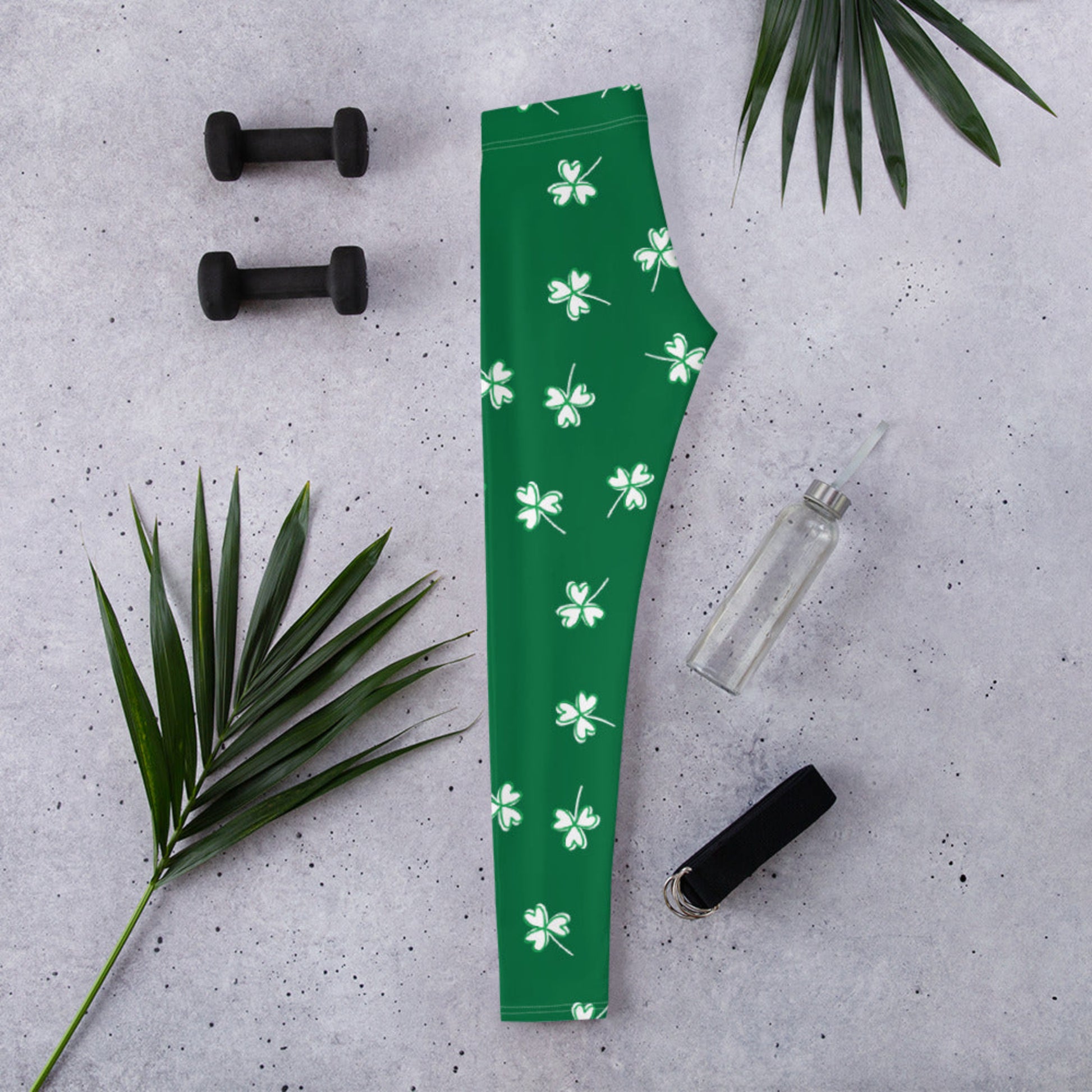 Women's green yoga leggings with white clover print design, comfortable mid rise waist, stretchy fabric, and festive St. Patrick's Day style for everyday wear with white clover print design, comfortable mid rise waist, stretchy fabric, and festive St. Patrick's Day style for everyday wear