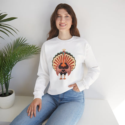 A woman wearing a white crewneck sweatshirt with a colorful embroidered turkey graphic on the front, paired with blue jeans, sitting on a white bench next to a potted plant. Family matching Thanksgiving sweatshirt with a cheerful cartoon turkey holding its wings together in a heart shape, available in adult and child sizes for festive holiday outfits