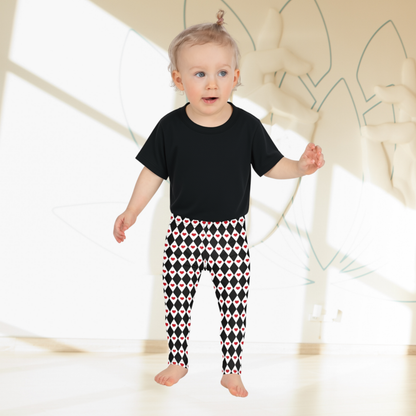 A pair of toddler girls leggings covered in black and white diamonds with small red hearts throughout the pattern. The bold contrast gives this playful design a fun theatrical feel while remaining easy to style with everyday clothing. These full length leggings have a high waisted fit and stretchy fabric, making them a comfortable choice for girls and tweens who enjoy unique patterns.