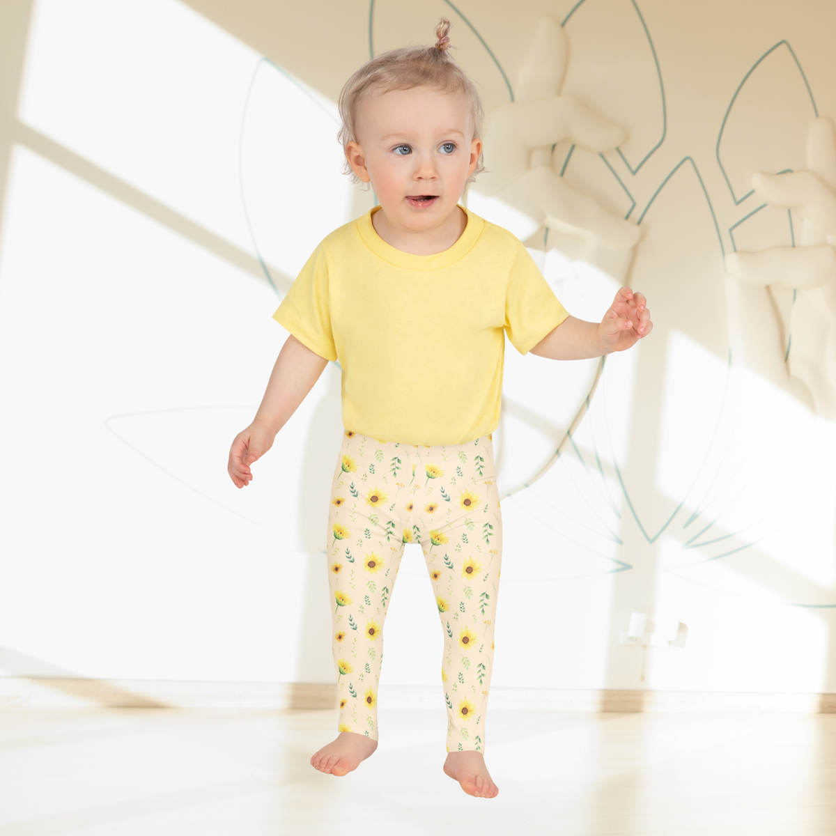 Girls leggings decorated with yellow sunflowers, green foliage, leafy stems and small botanical flowers on a soft cream background. The warm colors and natural floral arrangement give the design a vintage botanical and cottage garden feeling. These wildflower leggings are an easy choice for girls who enjoy floral clothing, nature inspired outfits and cheerful colors. They work especially well for spring, summer, family photos, garden visits and casual everyday style.