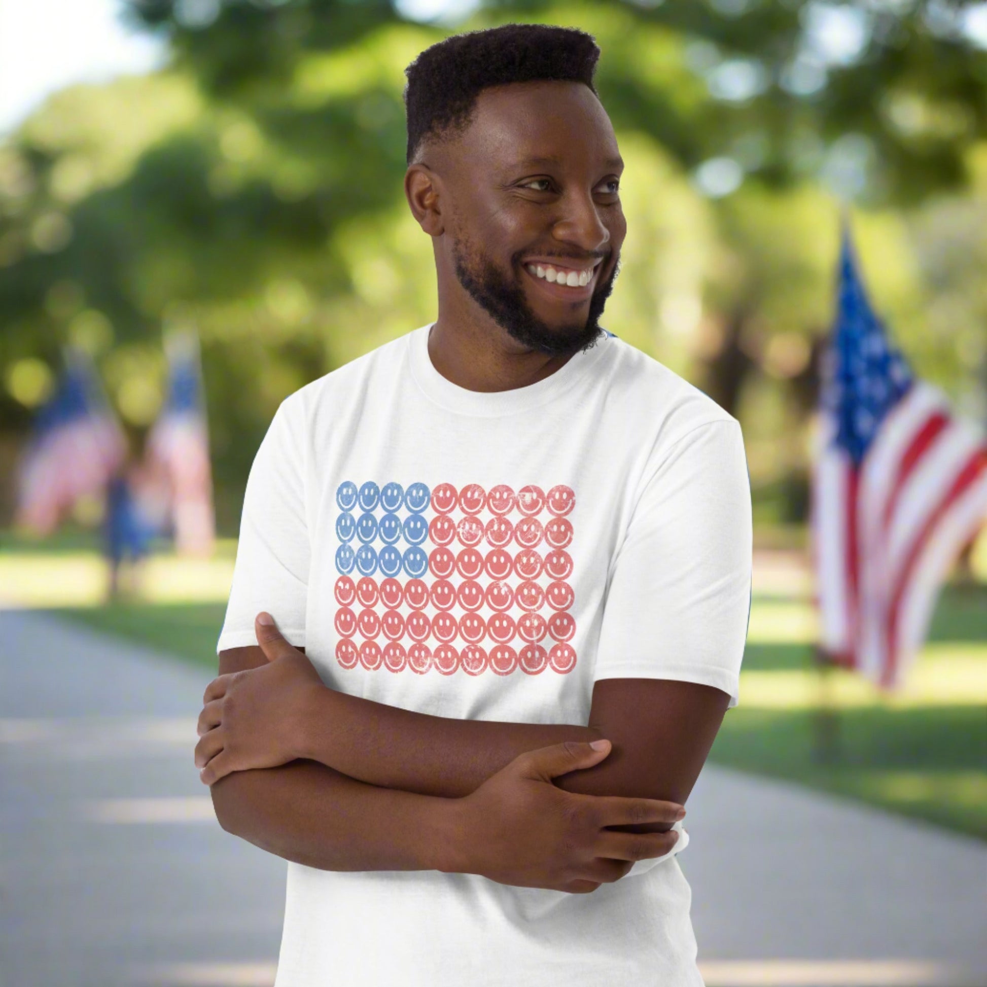 White adult tshirt, featuring a Fourth of July pattern of red and blue smiley faces which form an American flag. by jaecrece.com