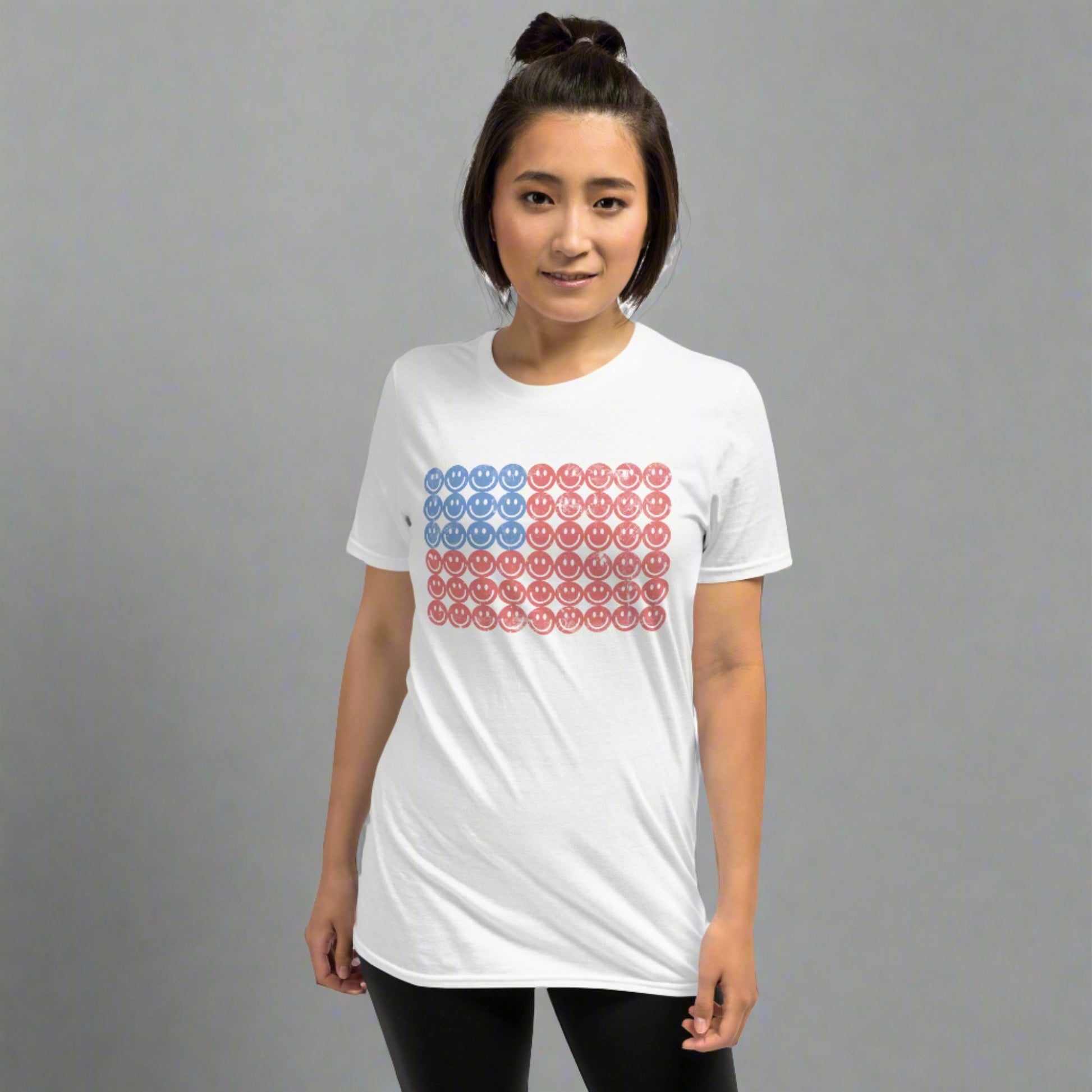 White adult tshirt, featuring a Fourth of July pattern of red and blue smiley faces which form an American flag. by jaecrece.com