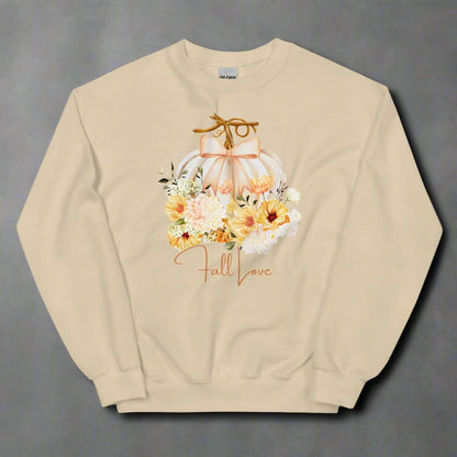 Fall Love Ladies Sweatshirt, this is a Sand colored Gildan Sweatshirt, with a graphic of a white pumpkin with a peach ribbon. The pumpkin is surrounded by a garland of fall leaves and flowers, with the text- Fall Love, by jaecrece