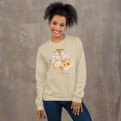 Fall Love Ladies Sweatshirt, this is a Sand colored Gildan Sweatshirt, with a graphic of a white pumpkin with a peach ribbon. The pumpkin is surrounded by a garland of fall leaves and flowers, with the text- Fall Love, by jaecrece