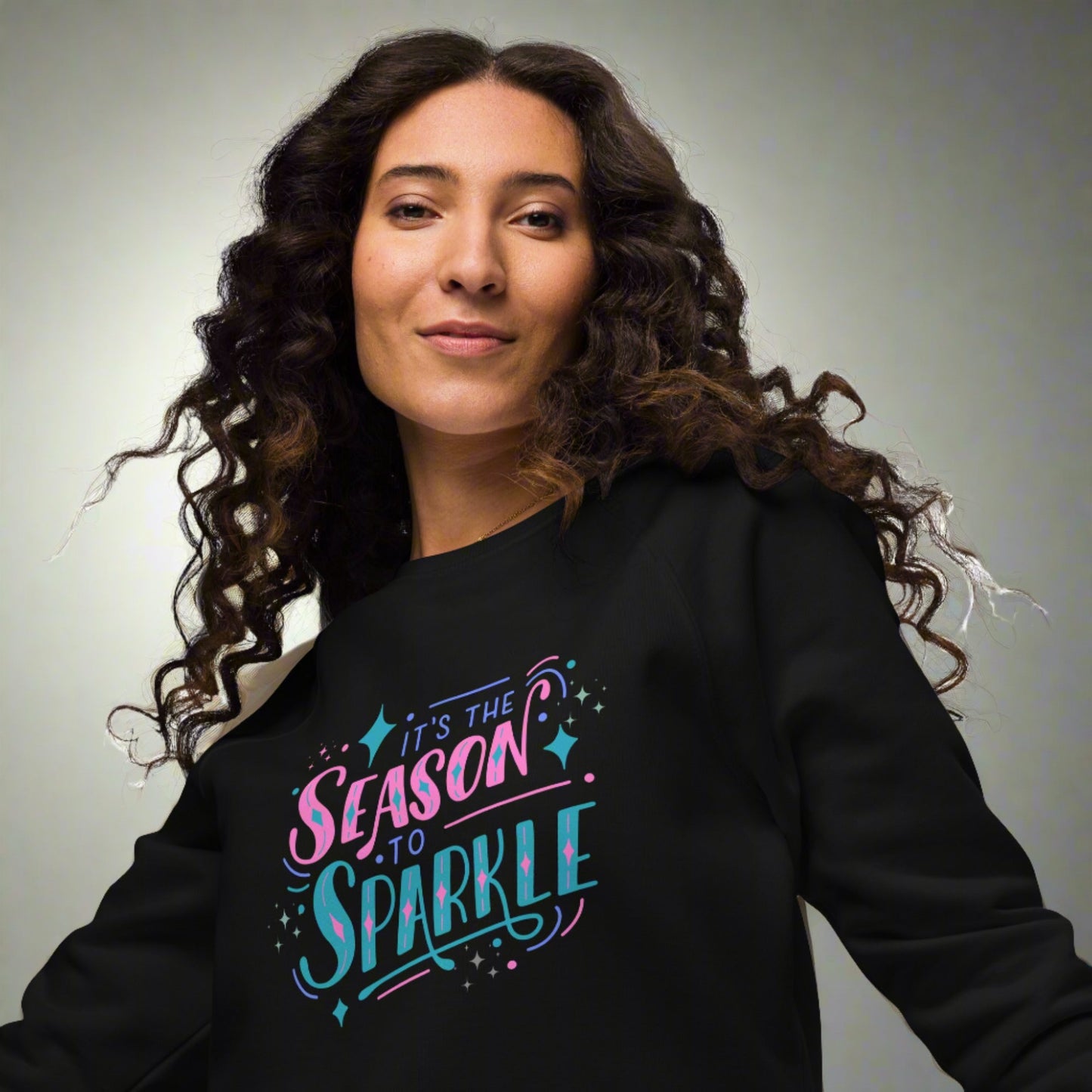 100% organic cotton sweatshirt that reads "it's the season to sparkle" in pink and teal lettering. Extended/ plus size available. By jaecrece.com