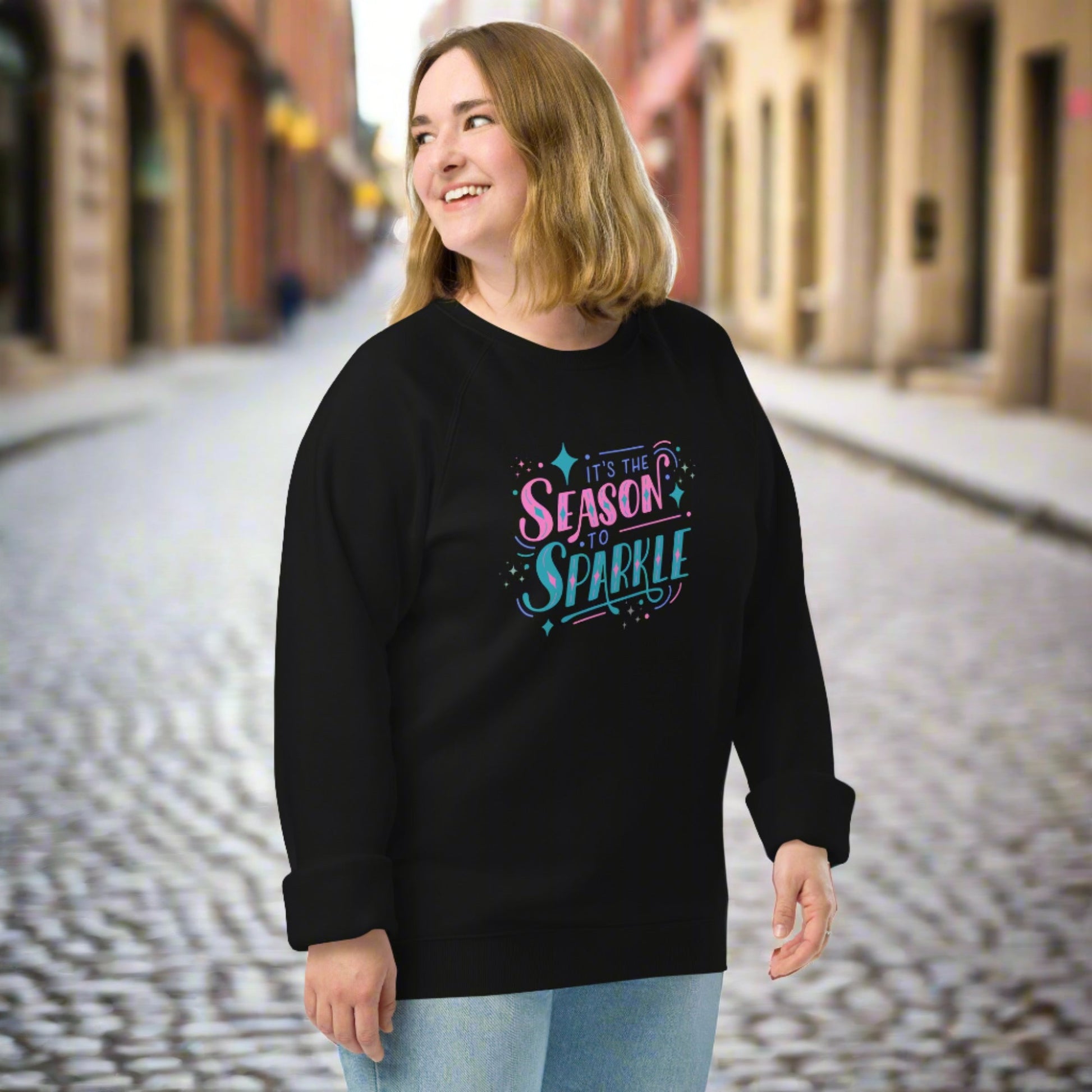 100% organic cotton sweatshirt that reads "it's the season to sparkle" in pink and teal lettering. Extended/ plus size available. By jaecrece.com