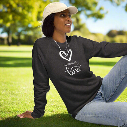 All You Need is Love Organic Sweatshirt. Image features a white heart, and the text "All You Need is Love"