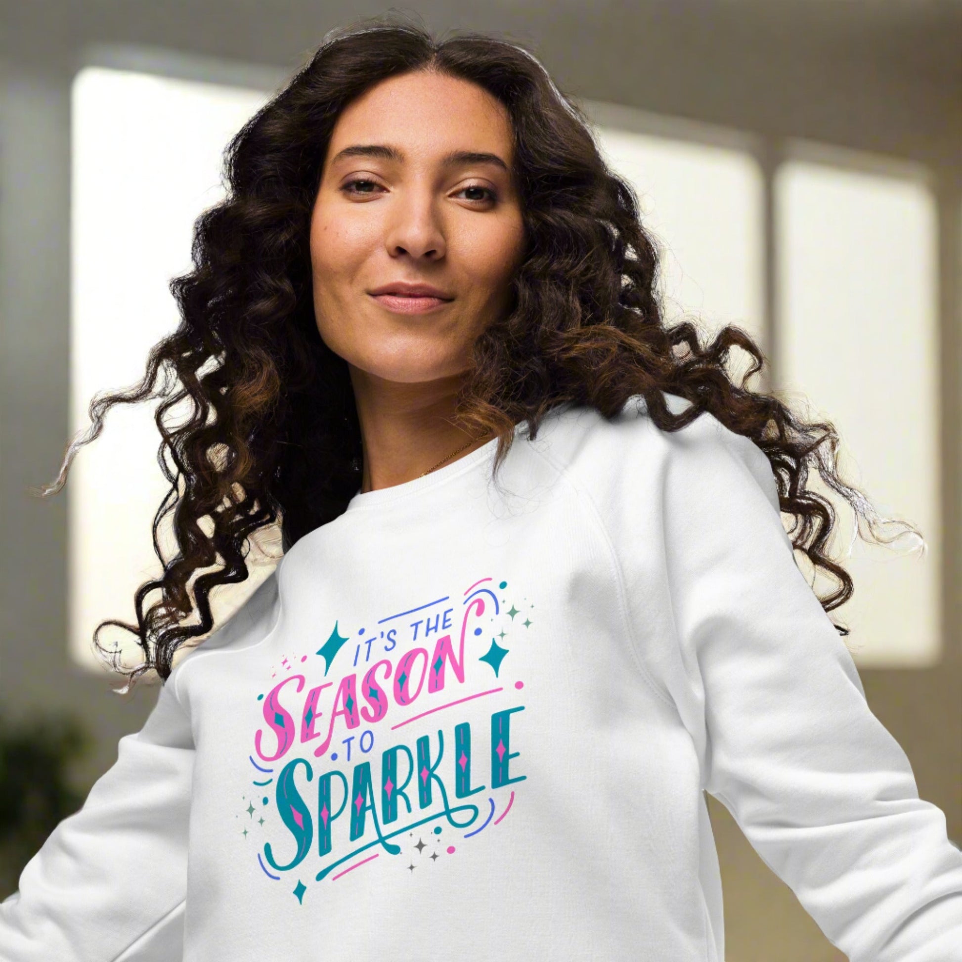 100% organic cotton sweatshirt that reads "it's the season to sparkle" in pink and teal lettering. Extended/ plus size available. By jaecrece.com