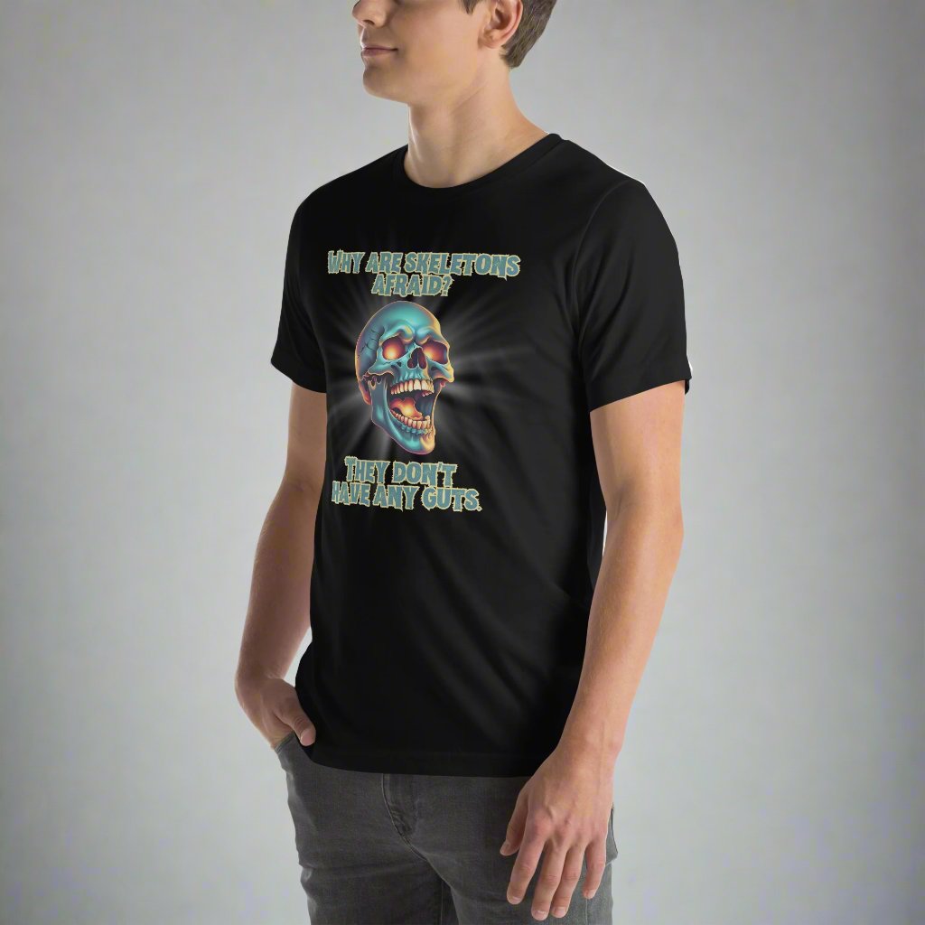 Black adult Unisex tee, featuring a large graphic of a laughing skeleton skull. The text reads" Why are skeletons afraid? They don't have any guts."  by jaecrece.com