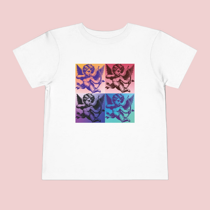 Let your toddler express their playful side with this Pop Art Cupid T-shirt. Featuring a whimsical, vintage-inspired Cupid graphic, this tee comes in sizes 2T-5T and colors Black, White, and Pink. The super-soft fabric ensures comfort, while the fun design adds a pop of retro flair. Perfect for casual wear, family matching, or celebrating Valentine's Day, this t-shirt is a must-have for little ones who love artsy and expressive fashion.