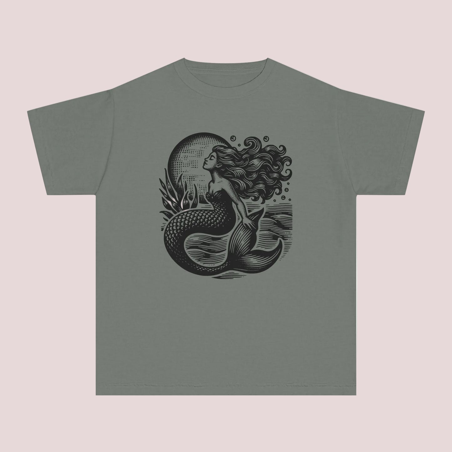 Vintage coastal girls t shirt featuring a detailed linocut inspired mermaid graphic with dark ocean waves and moonlit seaside artwork. Printed on a soft garment dyed Comfort Colors youth tee designed for comfort style and everyday wear. Perfect for beach lovers mermaid fans seaside vacations summer camps coastal family photos and trendy ocean aesthetic outfits. Relaxed fit cotton graphic shirt pairs perfectly with denim shorts leggings and layered beachy fashion looks.