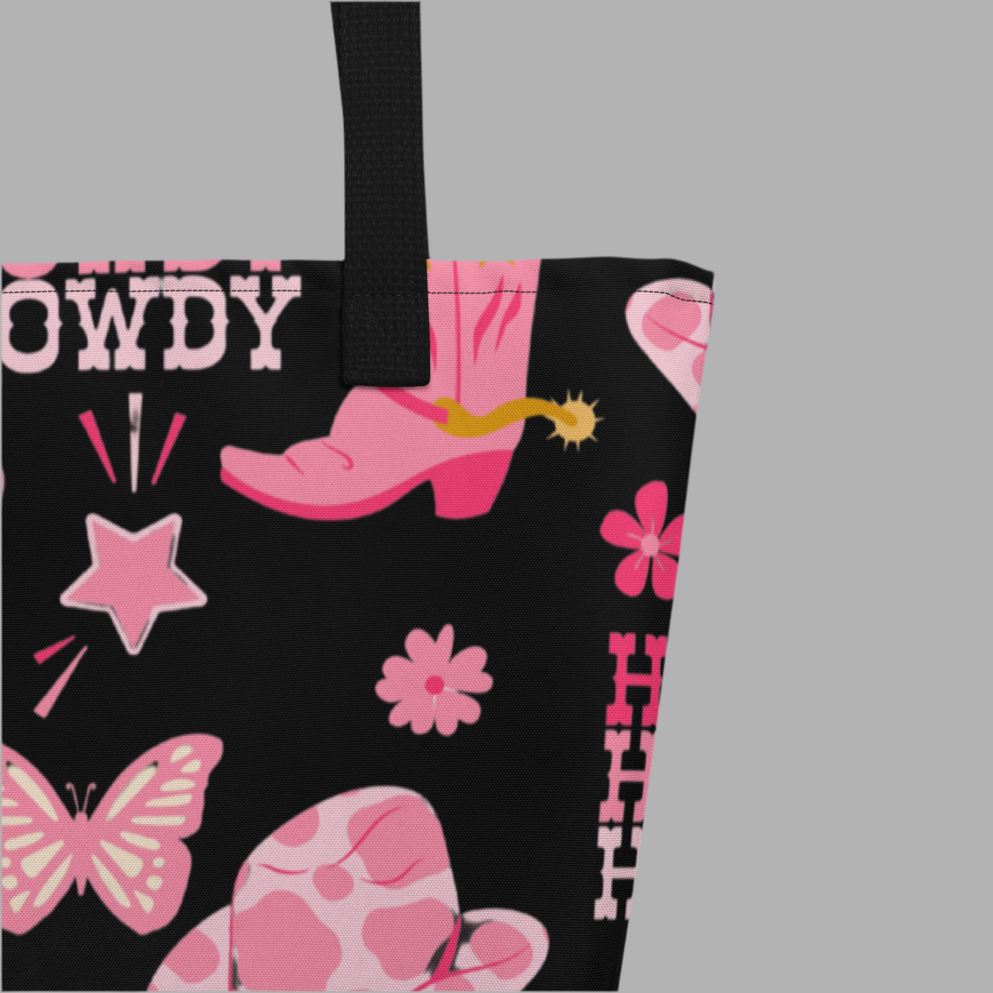 Image: Disco Cowgirl Tote Bag. This western glam canvas shoulder bag has a black background with a pink, white and pink pattern of butterflies, daisies, cowgirl hats and boots. The text on the bag reads Howdy, Yee-Haw and Disco Cowgirl. Great for weekend girls trips or bachelorette parties in Nashville, by jaecrece