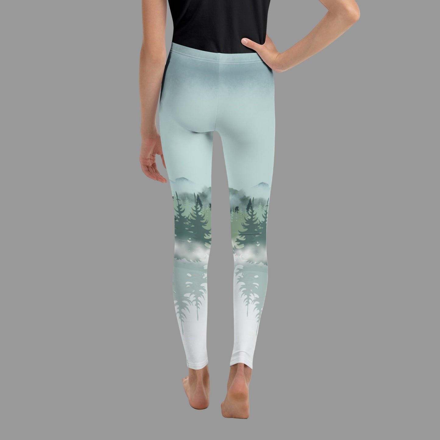 Kids Winter Forest Leggings with a nature-inspired snowy mountain and pine tree design, available in sizes 8–20. These family matching leggings are perfect for winter holidays, mountain vacations, ski lodge activities, outdoor adventures, and coordinated family photo outfits. Smooth, stretchy microfiber yarn with overlock stitching ensures comfort, durability, and a soft feel, supporting eco-friendly made-to-order production.