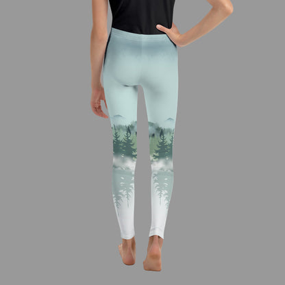 Kids Winter Forest Leggings with a nature-inspired snowy mountain and pine tree design, available in sizes 8–20. These family matching leggings are perfect for winter holidays, mountain vacations, ski lodge activities, outdoor adventures, and coordinated family photo outfits. Smooth, stretchy microfiber yarn with overlock stitching ensures comfort, durability, and a soft feel, supporting eco-friendly made-to-order production.
