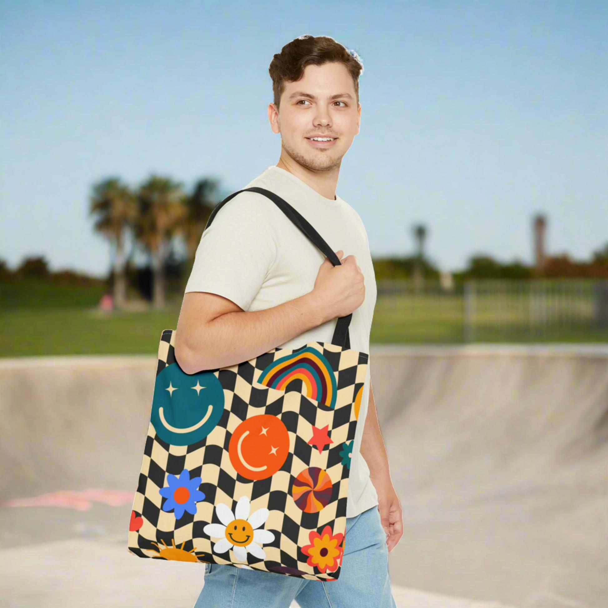 y2k Smiley Face Checkerboard Canvas Tote Bag. This cute reusable carryall is eco friendly, and features a black and khaki checkerboard background, with smiley face, rainbow and daisy graphics. by jaecrece.com
