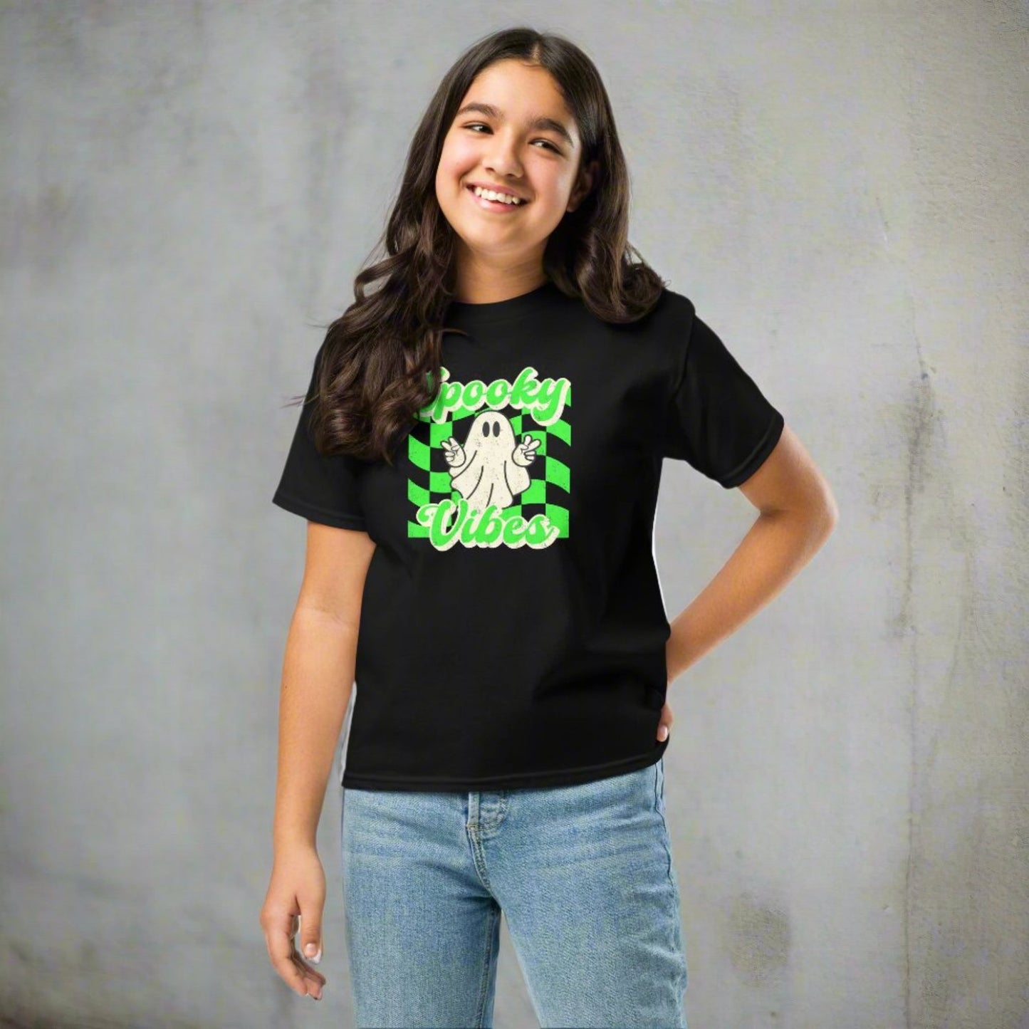 Black Spooky Vibes Child Shirt with a bright green checkerboard pattern and a cute ghost showing the peace sign. The text reads Spooky Vibes. This Halloween tee is perfect for girls and boys! By jaecrece