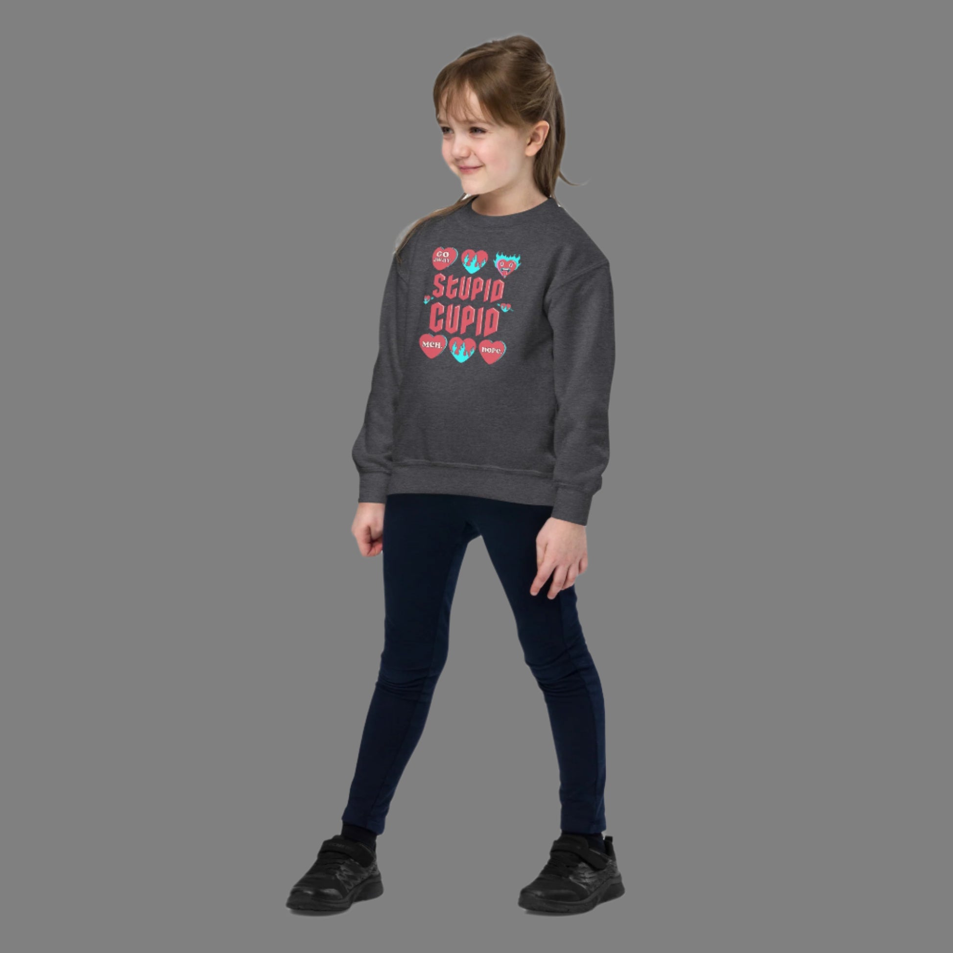 Image: Stupid Cupid Anti Valentines Day T-shirt for Kids. This sweatshirt is for girls and boys with red 90s style text that reads Stupid Cupid, with conversation hearts that are on fire, or say Go Away, Meh, Nope. Great for school party, by jaecrece