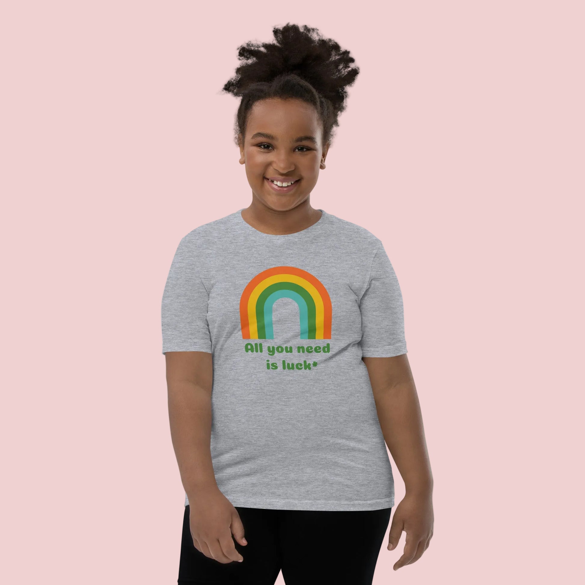 Bella Canvas youth St Patricks Day t shirt with All You Need Is Luck message and lucky shamrock clover graphic. Fun festive kids shirt for school celebrations, parades, Irish holiday events, and family St Patrick's Day photos.