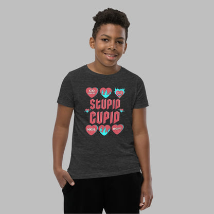 Image: Stupid Cupid Anti Valentines Day T-shirt for Kids. This sweatshirt is for girls and boys with red 90s style text that reads Stupid Cupid, with conversation hearts that are on fire, or say Go Away, Meh, Nope. Great for school party, by jaecrece