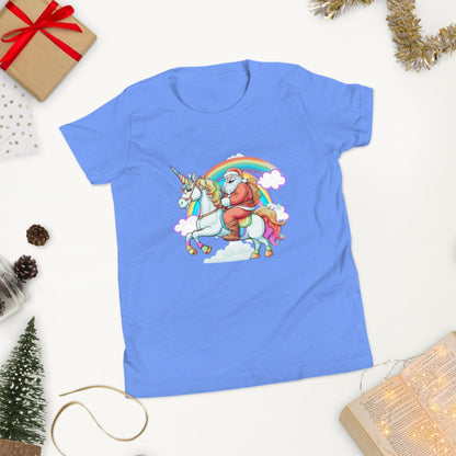 Image: Blue short sleeve tshirt with a printed graphic of Santa riding a unicorn over a rainbow. This whimsical girls shirt is a perfect birthday gift for christmas present, by jaecrece