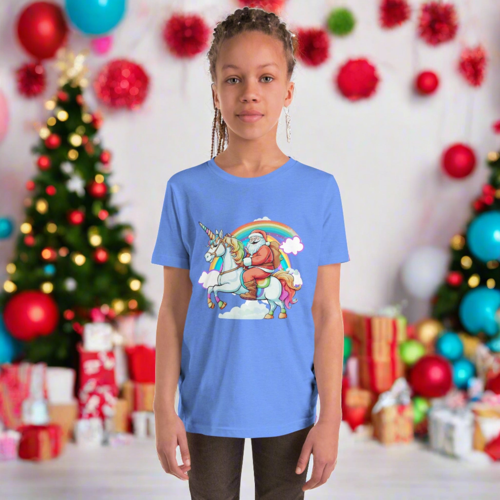 Alt Text: Bluw short sleeve tshirt, featuring a whimsical scene of Santa riding on a unicorn over a rainbow with clouds