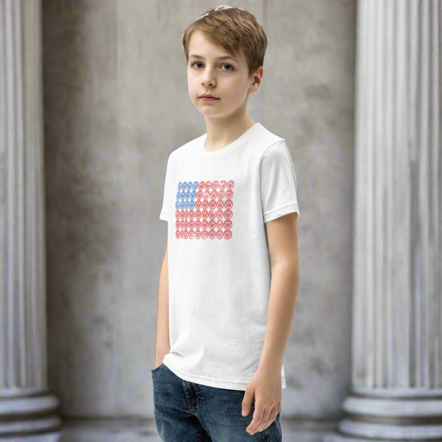 White unisex patriotic shirt for boys and girls. The graphic is an American flag, made up of Blue and Red Vintage smiley faces, by jaecrece.com