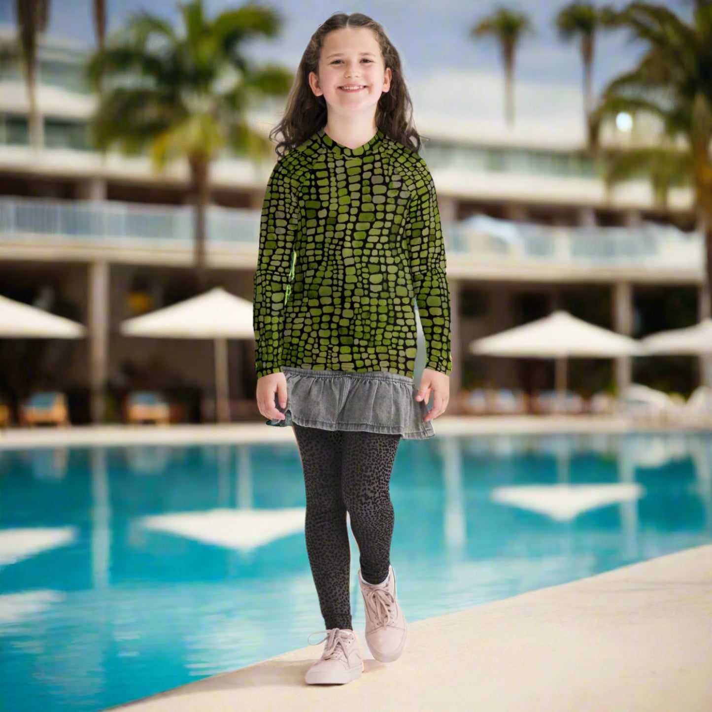This youth reptile rash guard (sizes 8–20) features a vivid green scale print inspired by dinosaurs and snakes, making it ideal for costumes, beach play, and outdoor fun. UPF sun protection, stretchy comfort, and eye-catching design make it great for water parks or backyard splash days. Perfect for imaginative kids who love reptiles, wild animal themes, and summer adventures in style.